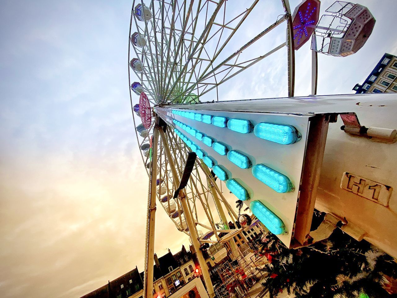 LOW ANGLE VIEW OF FERRIS WHEEL IN CITY AGAINST SKY