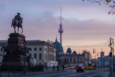 View of buildings in city against cloudy sky