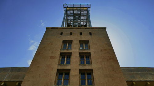 Low angle view of building against blue sky