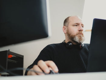 Young man using laptop at home