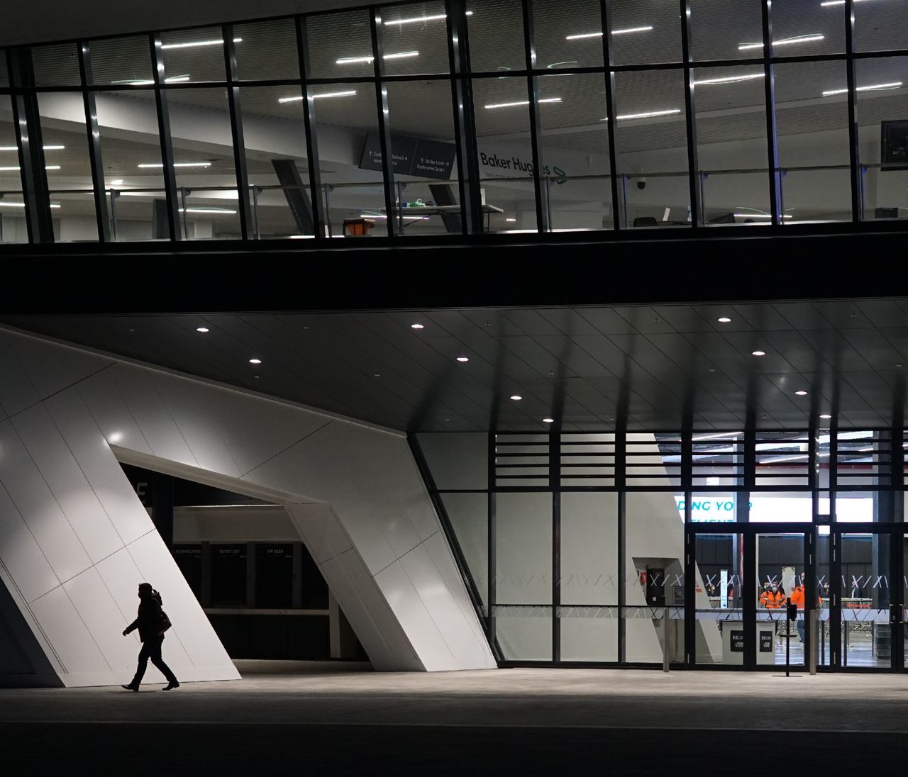 MAN WALKING IN MODERN BUILDING