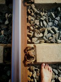 Close-up of hand on railroad track