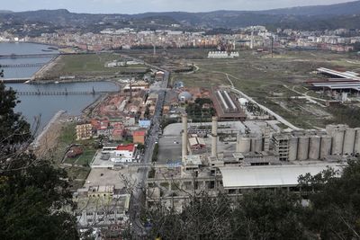 High angle view of townscape by river in city