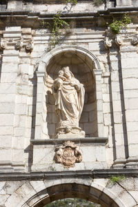 Low angle view of statue against building