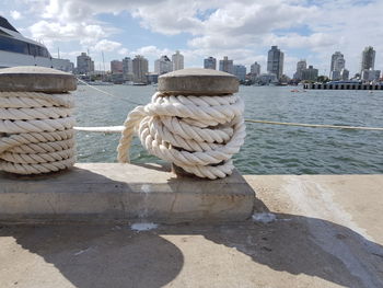 View of harbor by sea against sky in city