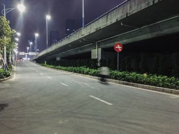 Road sign on street in city at night