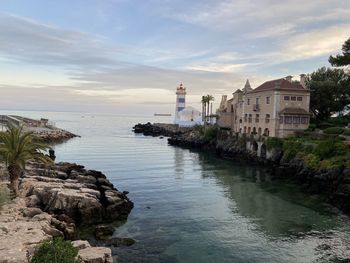 Scenic view of sea and buildings against sky