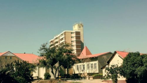 Residential buildings against clear blue sky