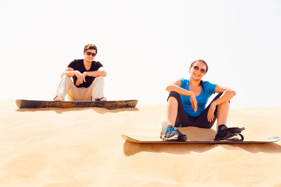 Young couple sitting on beach