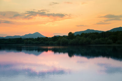 Scenic view of lake against sky during sunset