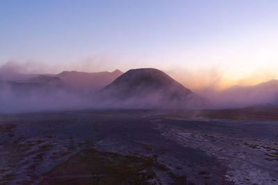 Scenic view of volcano against clear sky during sunset