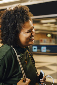 Female student laughing at subway station