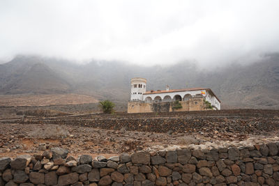 View of stone wall with mountain in background