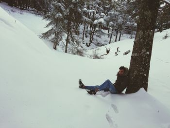 Man skiing on snow covered field