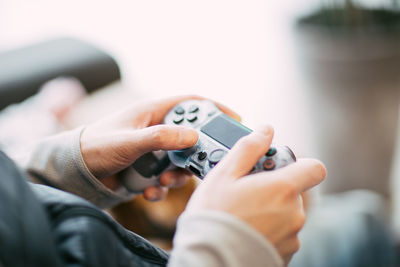 Midsection of man playing video game at home