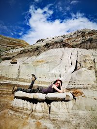 Portrait of woman sitting on rock