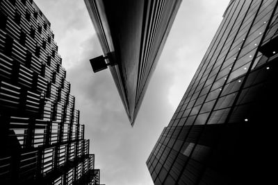 Epic low angle view of modern buildings against sky black and white