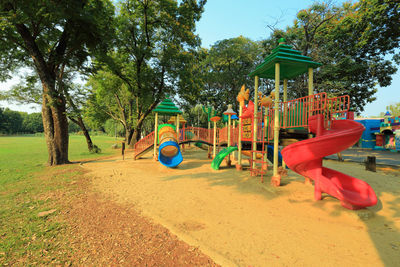 View of playground against trees in park