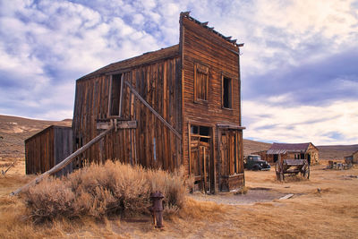 Old building on field against sky