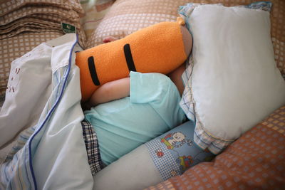 High angle view of child relaxing on bed at home