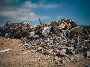 Garbage in field against sky