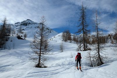 Full length of man on snow covered landscape against sky