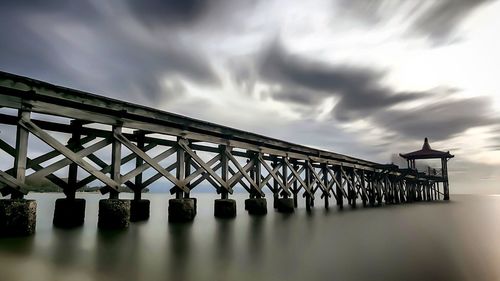 Low angle view of bridge over calm sea