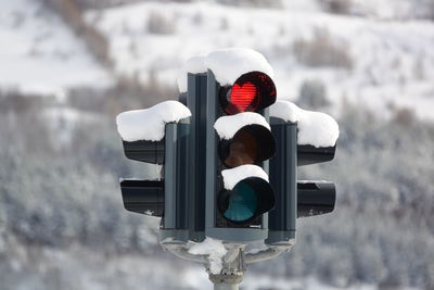 Road sign on snow covered street light