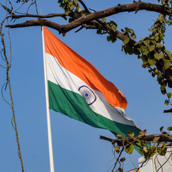 India flag flying high at connaught place with pride in blue sky, india flag fluttering, indian flag