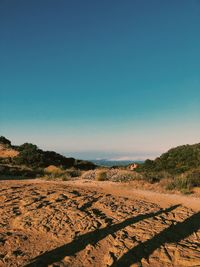 Scenic view of desert against clear blue sky