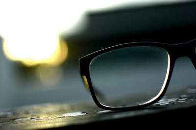 Close-up of sunglasses with reflection against sky