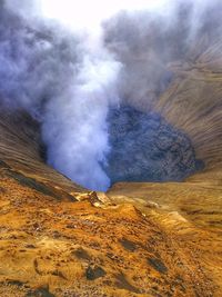 Scenic view of steam emitting from geyser