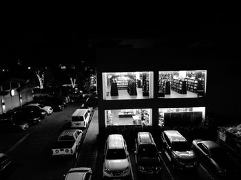 Cars in illuminated city at night