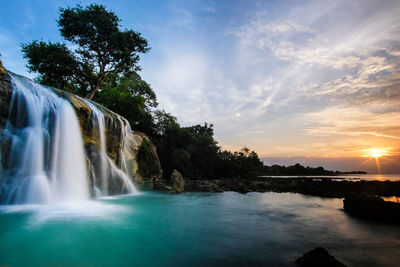 The view of beautiful sunset and long exposure toroan waterfall with turquoise water