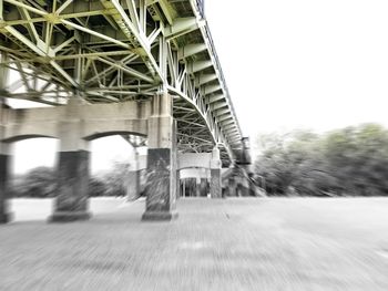 Blurred motion of bridge in city against clear sky