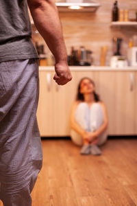 Low section of young woman standing on floor