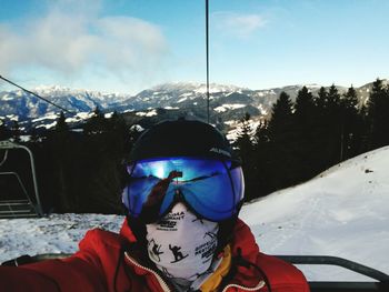 Mid adult man in snow against mountain range