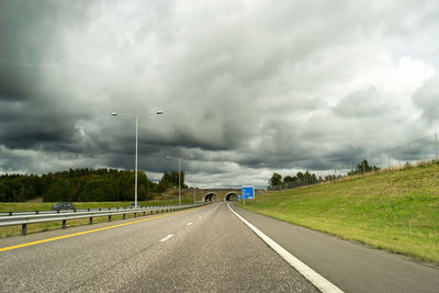 Highway against storm clouds