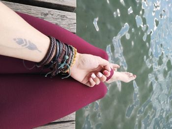 High angle view of woman hands in water