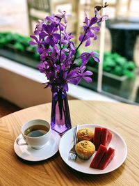 High angle view of breakfast by vase on table