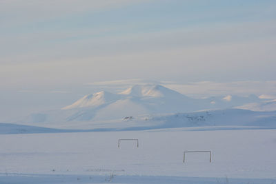 Scenic view of snow covered mountains against sky