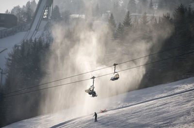 Overhead cable car against sky during winter