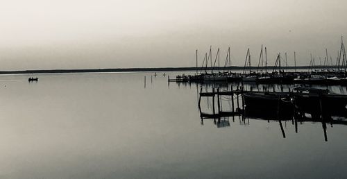 Sailboats in sea against sky