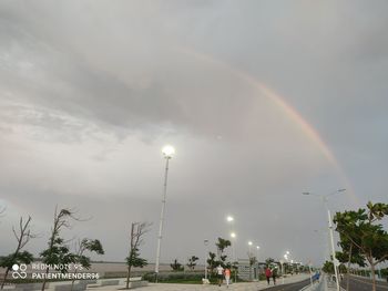 Low angle view of rainbow over street against sky