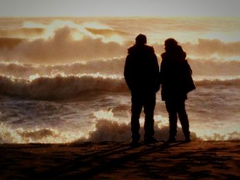 People on beach at sunset