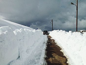 Snow covered car against sky