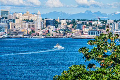 Scenic view of sea by buildings against sky