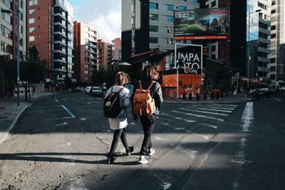Full length of man walking on road in city