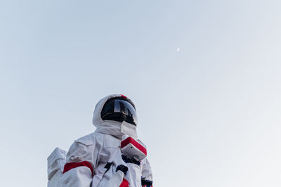 Mid adult man standing below sky