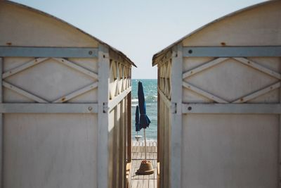 Beach huts against clear sky